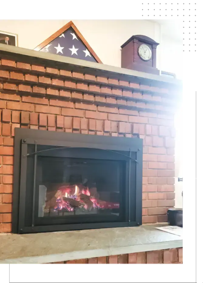 A fireplace with the door open and the fire burning.